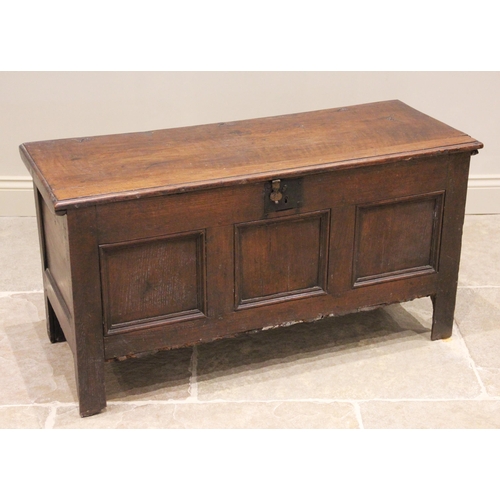 581 - An 18th century and later oak coffer, the rectangular moulded top above three invert moulded front p... 