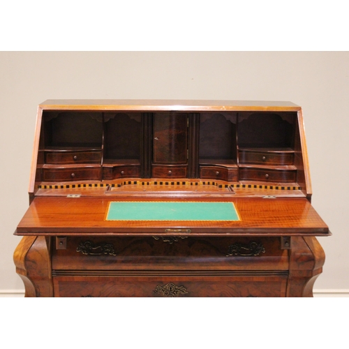 583 - A figured walnut Dutch style bombe bureau, late 20th century, the cross banded fall front opening to... 