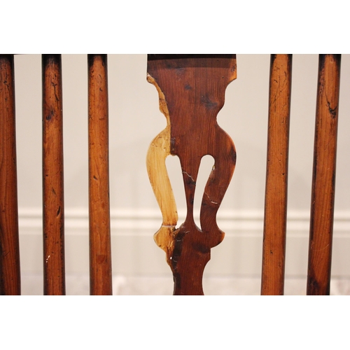 589 - A 19th century yew and ash hoop back Windsor elbow chair, with a pierced splat over a shaped seat ra... 