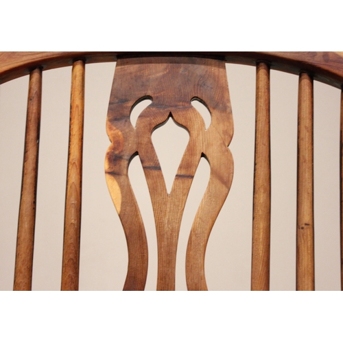 589 - A 19th century yew and ash hoop back Windsor elbow chair, with a pierced splat over a shaped seat ra... 