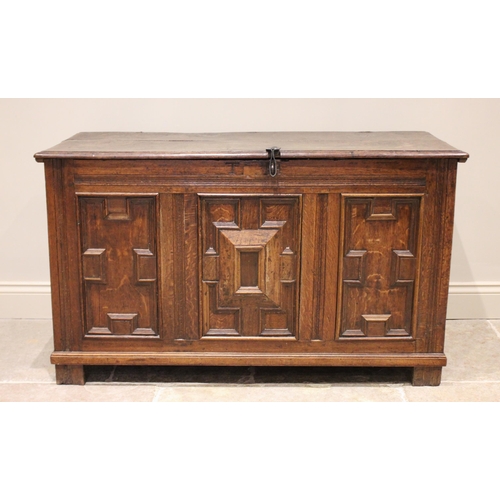 590 - A late 17th/early 18th century oak coffer, the twin plank moulded top opening to a fitted candle box... 