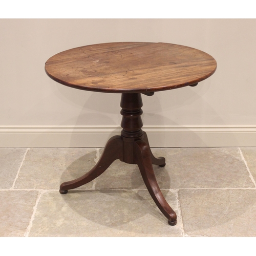 595 - A George III mahogany tripod table, the circular top raised upon a baluster pedestal extending to th... 