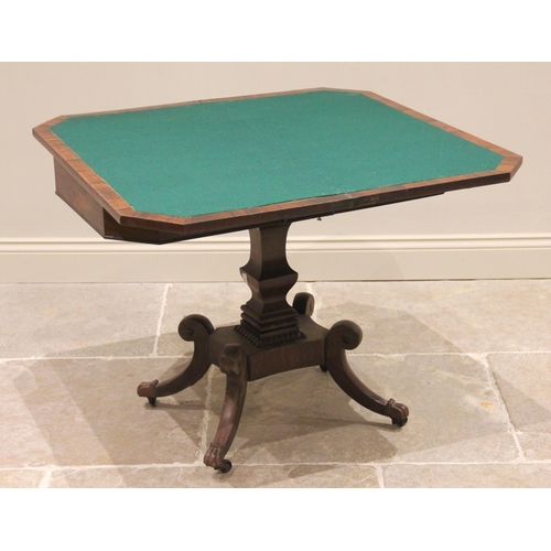 599 - A George IV mahogany and rosewood cross banded card table, the rectangular hinged top with canted fr... 