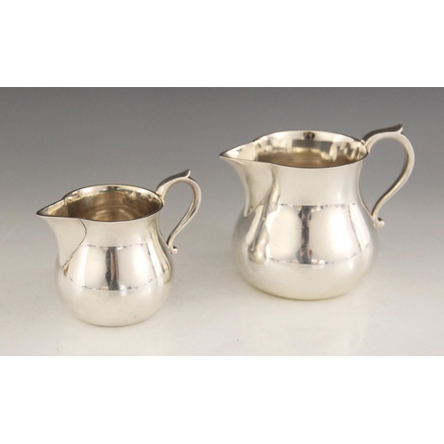 6 - A silver cream jug, Edward Barnard & Sons Ltd, London 1964, of plain polished baluster form with scr... 