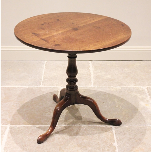 602 - A George III mahogany tripod table, the circular top upon a birdcage mechanism and an annulated balu... 