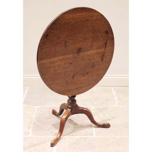 602 - A George III mahogany tripod table, the circular top upon a birdcage mechanism and an annulated balu... 