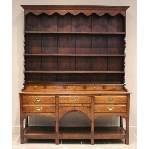 604 - A George III oak high back pot board dresser, the moulded cornice above a scalloped frieze and three... 