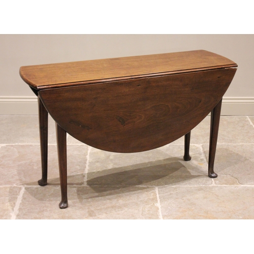 605 - A George II mahogany drop leaf table, the oval top raised upon tapering cylindrical legs and pad fee... 