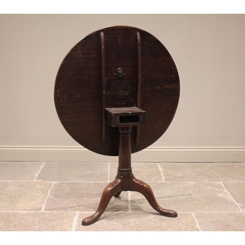 607 - A George III mahogany tilt top tripod table, the circular top raised upon a bird cage mechanism and ... 