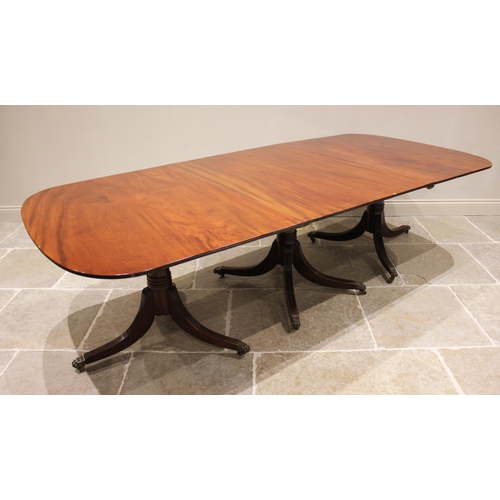 608 - A Regency style mahogany triple pillar dining table, early 20th century, possibly by Maple & Co, the... 