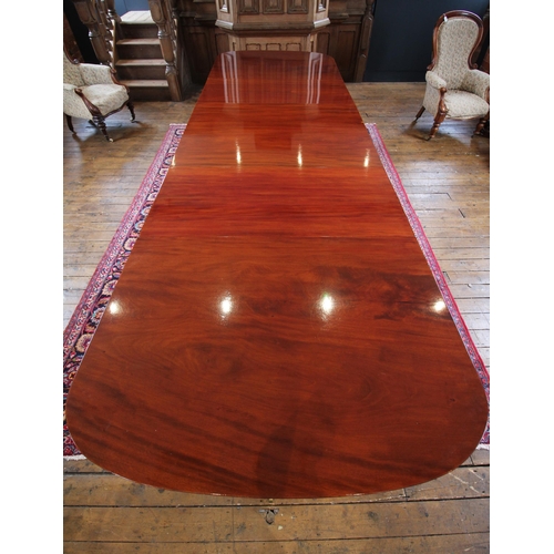 608 - A Regency style mahogany triple pillar dining table, early 20th century, possibly by Maple & Co, the... 