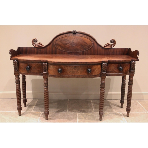 615 - A George III mahogany sideboard, the break arch raised back with a rope twist 'moustache' top rail, ... 