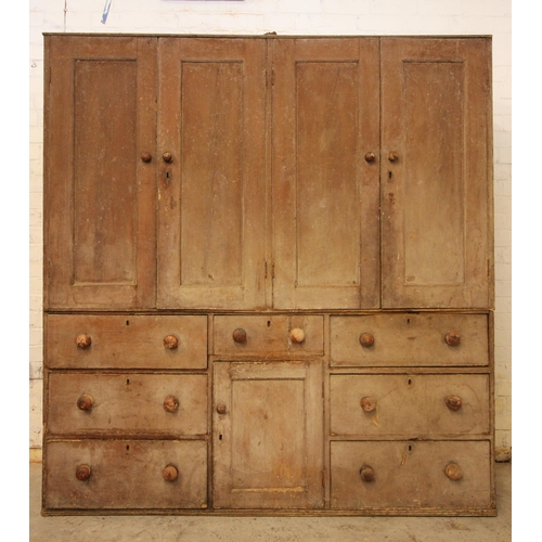 618 - A 19th century scumbled pine housekeepers cupboard, with four panelled cupboard doors above the base... 