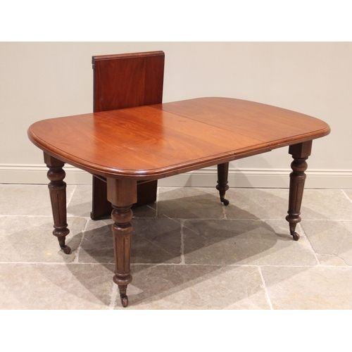 619 - A Victorian mahogany dining table, the rectangular top with rounded corners raised upon turned and f... 