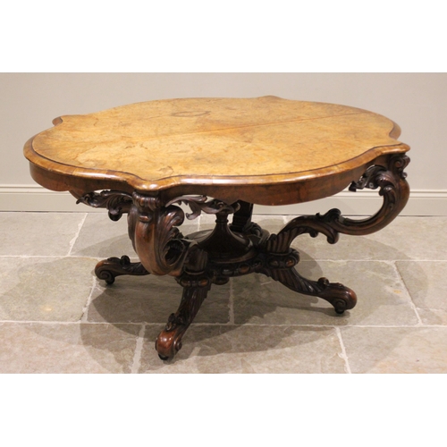 641 - A Victorian burr walnut centre table, the quarter veneered serpentine moulded top raised upon four c... 