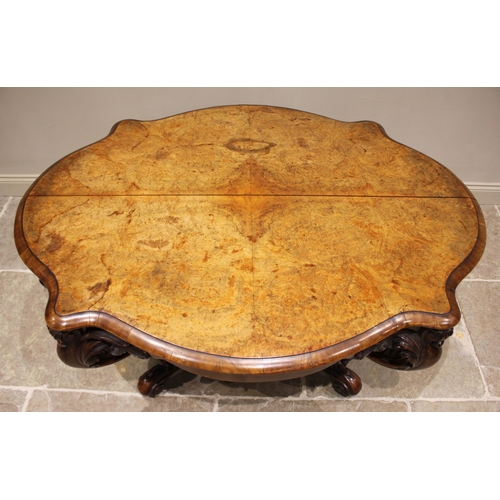 641 - A Victorian burr walnut centre table, the quarter veneered serpentine moulded top raised upon four c... 