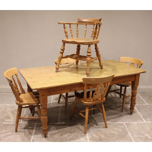 649 - A Victorian style pine kitchen table, the rectangular plank top raised upon turned legs and peg feet... 