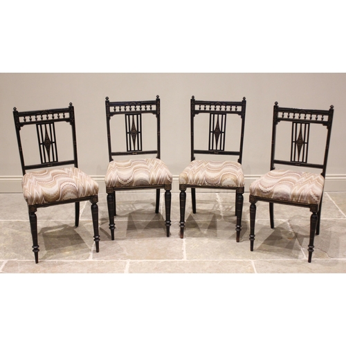 655 - A set of four Victorian Aesthetic Movement chairs, each with a spindled gallery over an open work sp... 