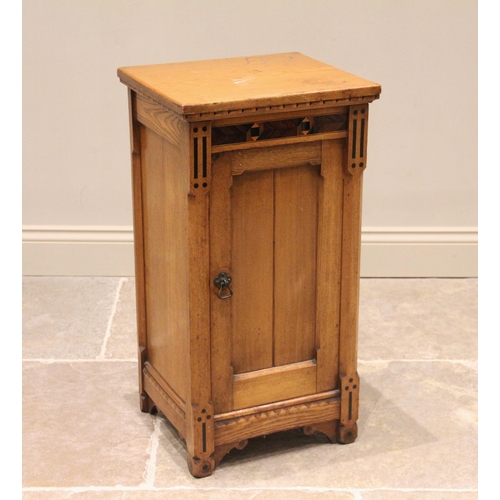 659 - A late 19th century ash Aesthetic Movement pot cupboard, the rectangular top with a simulated dentil... 