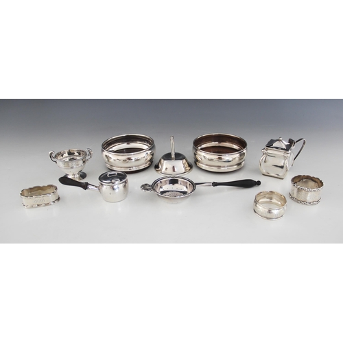 66 - A selection of silver and silver mounted tableware, to include a pair of silver mounted bottle coast... 