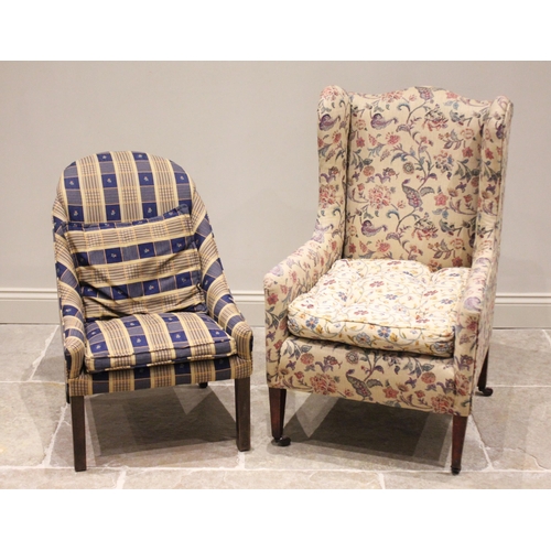 667 - An Edwardian wing back armchair, later re-covered in foliate fabric, the arched padded back extendin... 