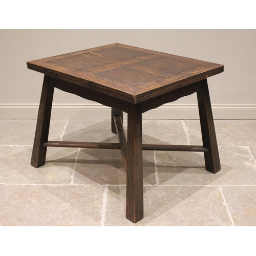 670 - An Arts & Crafts oak draw leaf table, purchased from Liberty, the rectangular draw leaf top above a ... 