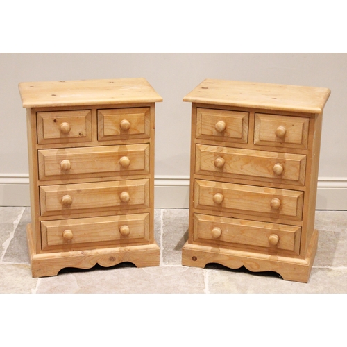 676 - A pair of modern pine bedside chests, each with an arrangement of two short over three long drawers,... 