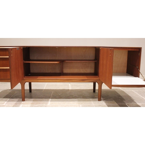 679 - A mid 20th century McIntosh of Kirkcaldy teak sideboard, the pair of central cupboard doors flanked ... 