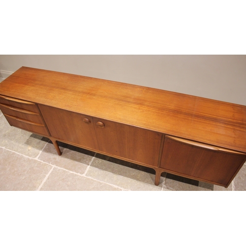 679 - A mid 20th century McIntosh of Kirkcaldy teak sideboard, the pair of central cupboard doors flanked ... 