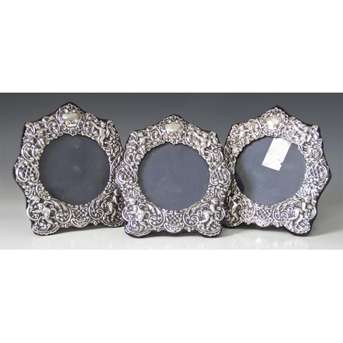 7 - A set of three silver mounted photograph frames, Keyford Frames Ltd, London 1982, the shaped borders... 