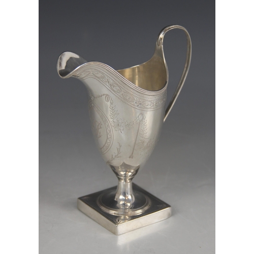 73 - A George III silver helmet shaped cream jug, Peter & Ann Bateman, London 1793, with bright cut decor... 