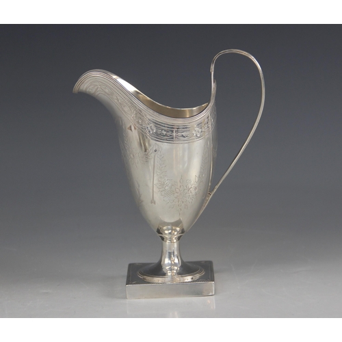 73 - A George III silver helmet shaped cream jug, Peter & Ann Bateman, London 1793, with bright cut decor... 