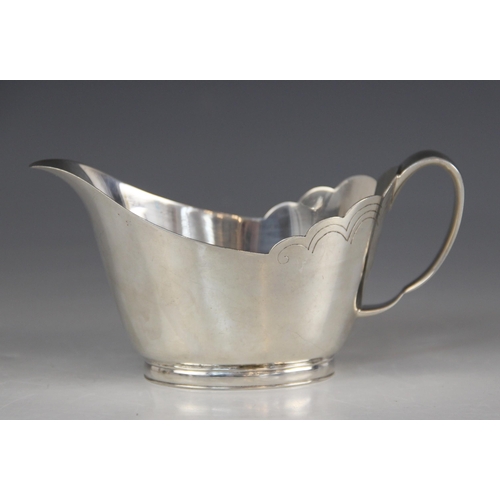 76 - A silver sauce boat, Mappin & Webb, Sheffield 1966, of tapering oval form with shaped border and loo... 