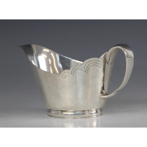 76 - A silver sauce boat, Mappin & Webb, Sheffield 1966, of tapering oval form with shaped border and loo... 