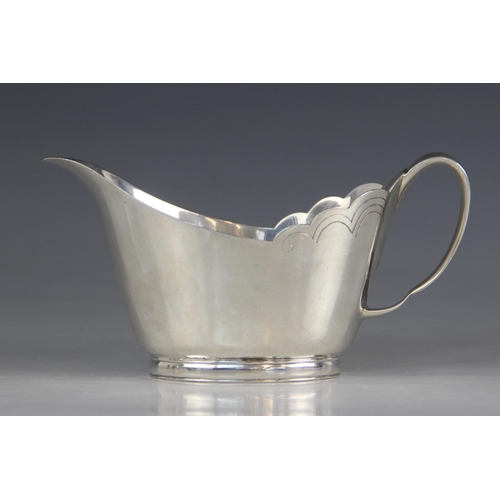 76 - A silver sauce boat, Mappin & Webb, Sheffield 1966, of tapering oval form with shaped border and loo... 