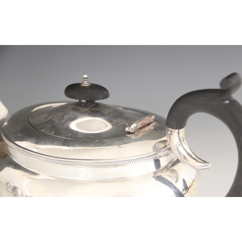 77 - A George V silver teapot, B Street & Co, Birmingham 1930, of compressed oval form with rope twist bo... 