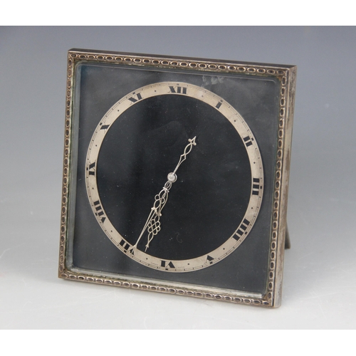 81 - A silver plated desk clock by Goldsmiths & Silversmiths Company, the square face set with circular c... 