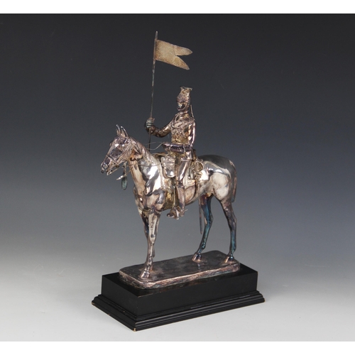 82 - A silver coloured model of a 17th lancer of the Royal Light Brigade, modelled on horseback, all upon... 