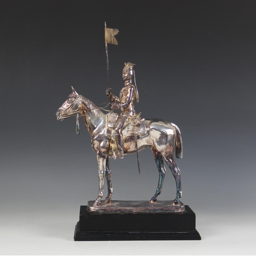 82 - A silver coloured model of a 17th lancer of the Royal Light Brigade, modelled on horseback, all upon... 