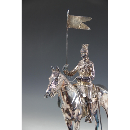 82 - A silver coloured model of a 17th lancer of the Royal Light Brigade, modelled on horseback, all upon... 