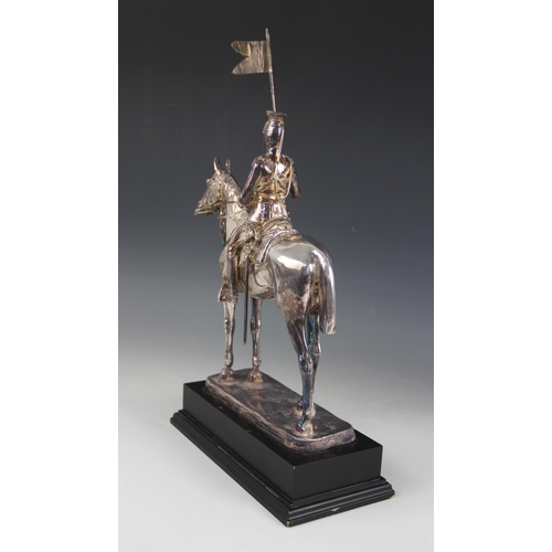 82 - A silver coloured model of a 17th lancer of the Royal Light Brigade, modelled on horseback, all upon... 