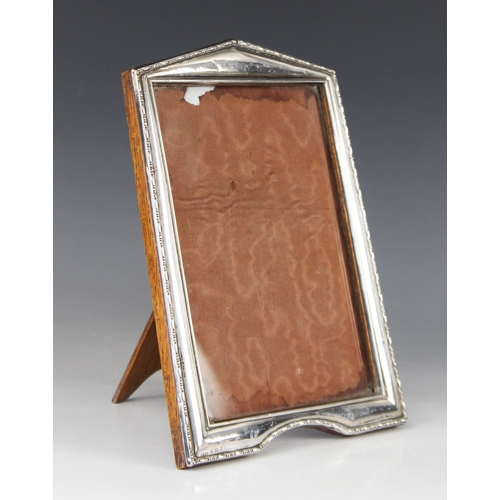 85 - An Art Deco silver mounted photograph frame, Henry Williamson Ltd, Birmingham 1921, of tapered recta... 