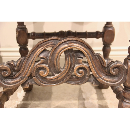 586 - A pair of 17th century and later walnut hall chairs, each with an arched and embossed leather back a... 