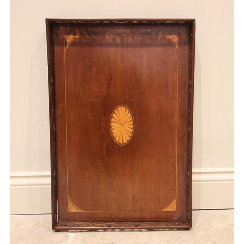 665 - An Edwardian mahogany galleried tray, the inlaid boxwood bat wing oval enclosed by conforming spandr... 