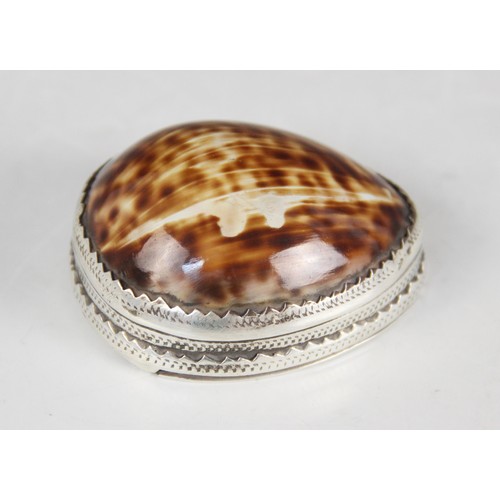 89 - An 18th century cowrie shell snuff box, the silver coloured mounts with punched dot detail, hinged c... 