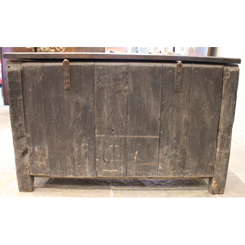 591 - An 18th century carved oak mule chest, the four panel hinged top over three front panels and two dra... 