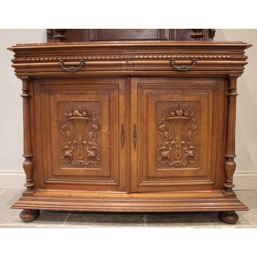 643 - A late 19th/early 20th century French carved oak and rouge marble buffet sideboard, the architectura... 