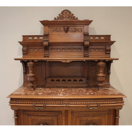 643 - A late 19th/early 20th century French carved oak and rouge marble buffet sideboard, the architectura... 