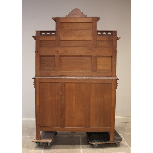 643 - A late 19th/early 20th century French carved oak and rouge marble buffet sideboard, the architectura... 