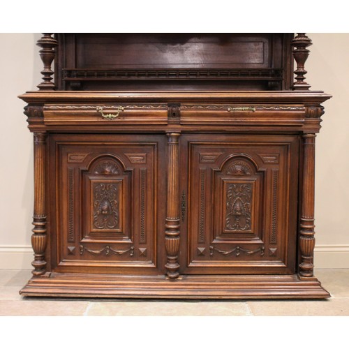 644 - A late 19th/early 20th century French walnut dresser, the raised back with a central carved cupboard... 